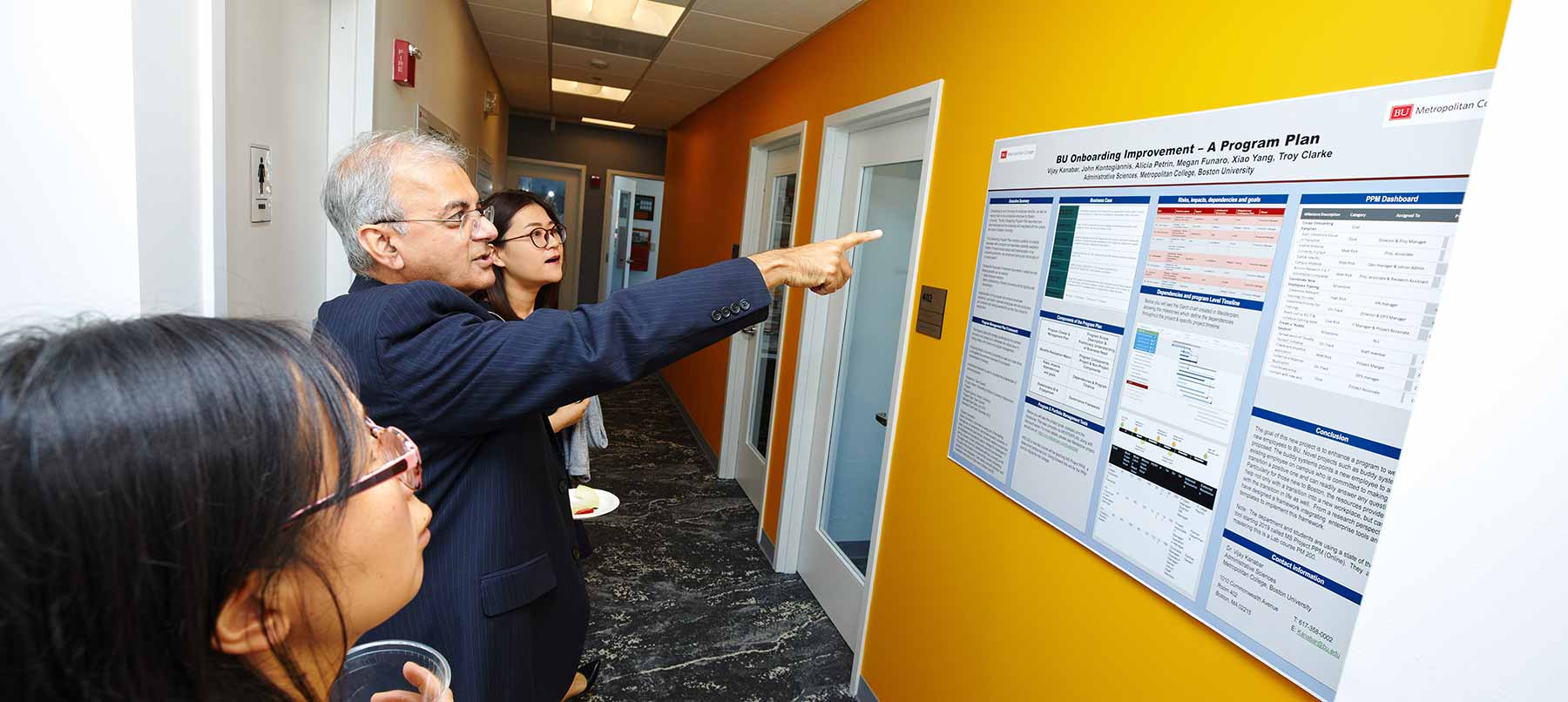 MET Professor Vijay Kanabar presenting a poster titled "Gfsntracker Onboarding Improvement - A Program Plan